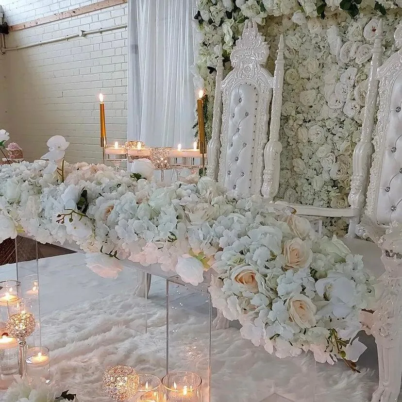 The hall dressed for a wedding, with white floral displays and candles