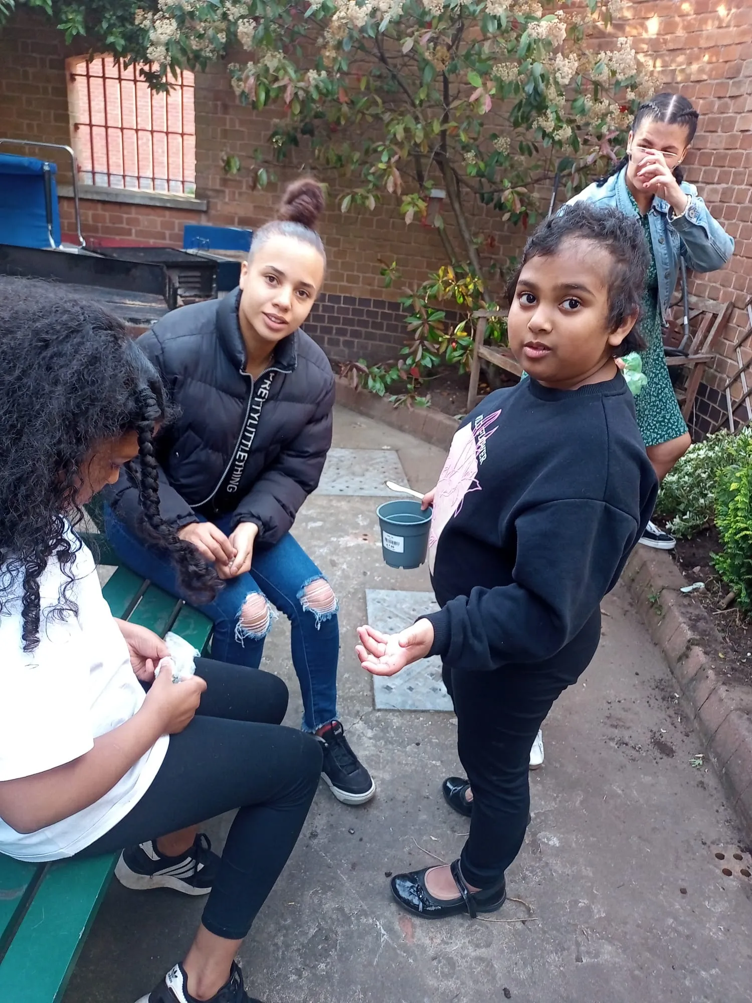 Children planting seedlings together in the club’s garden